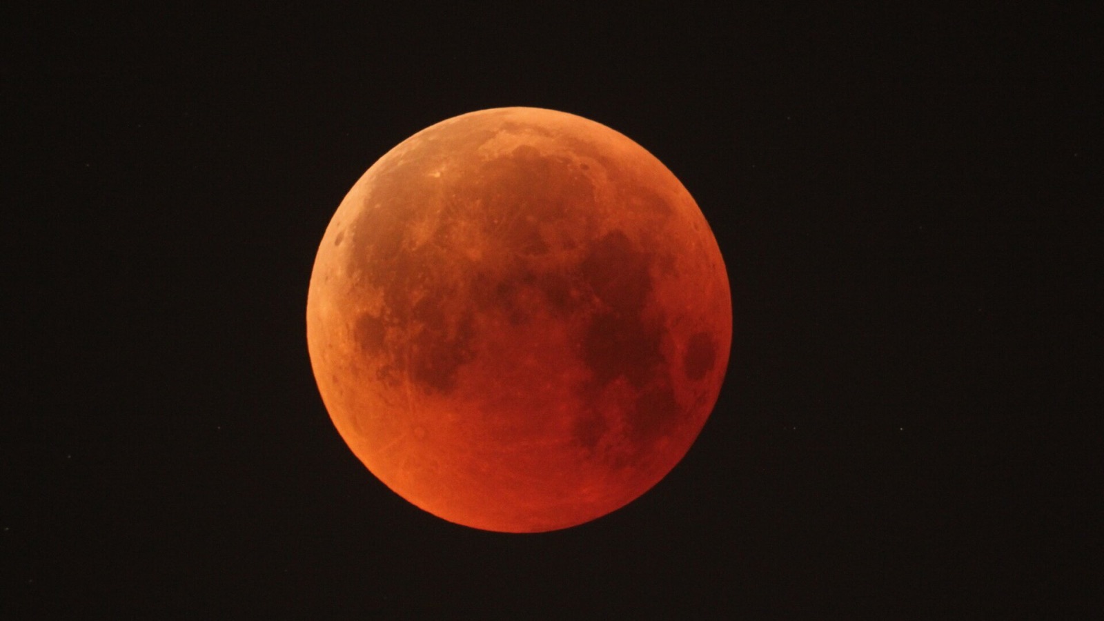 Sequence of lunar eclipse phases composited across the night sky